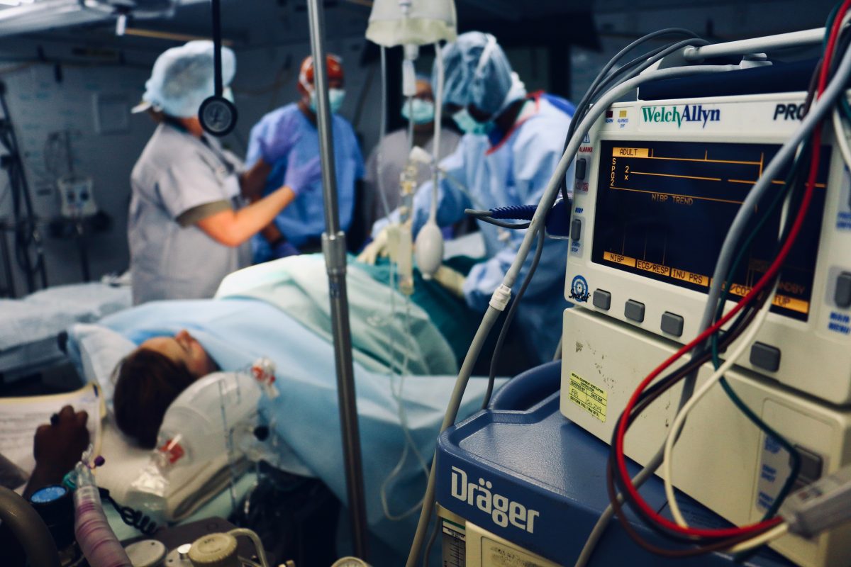 a shot inside of a surgery room with nurses and doctors in action