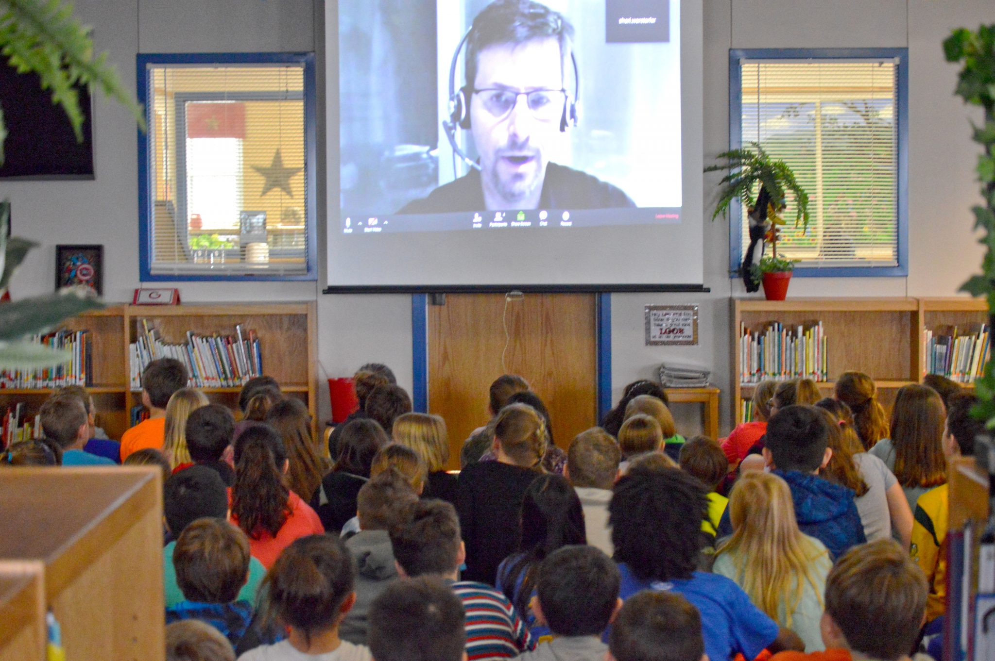 A professional addresses a class via video stream.