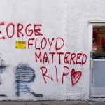 Graffiti on a wall reads "George Floyd Mattered R.I.P."