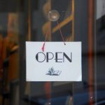 An open sign outside of a shop window