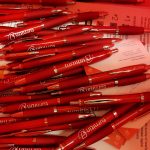 A pile of red Turnitin branded pens.
