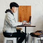 A tech student works at a cafe.