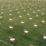 chairs laid out on a field so people can social distance for an education in 2021 graduation event.