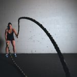 A woman trains with ropes