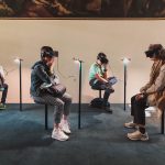 Museum goers access a VR installation.