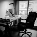 A home office is shot in black and white