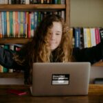 Young teen doing schoolwork at home after UK schools close due to the Coronavirus.