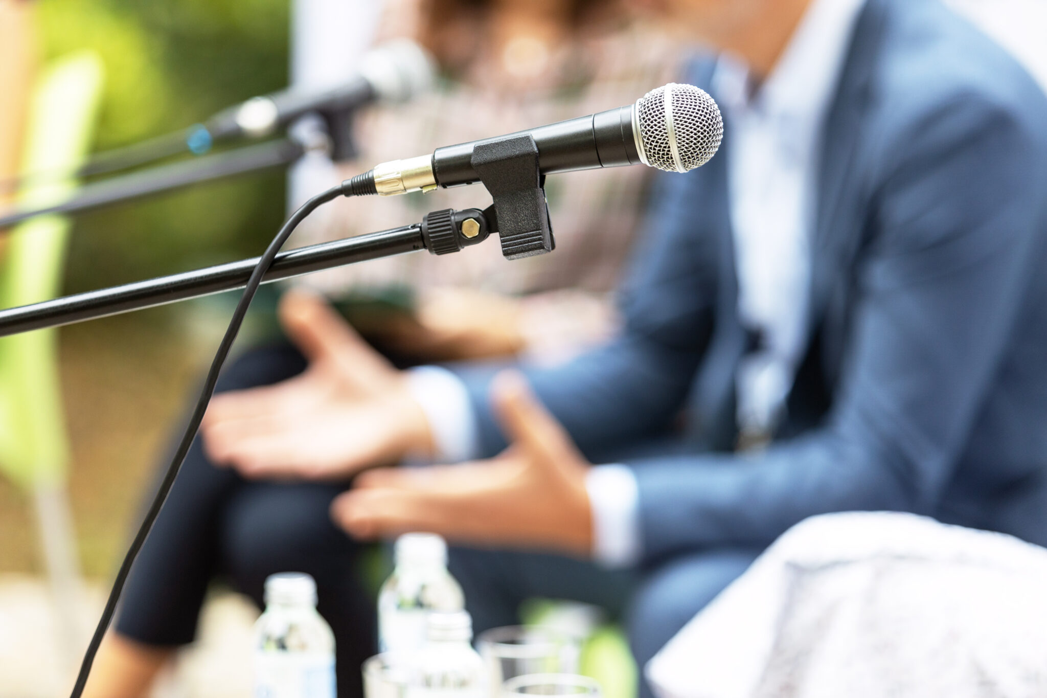 Zoom of a microphone and speakers surrounding it for an event. 