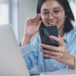 Asian business woman making facetime video call via mobile phone
