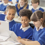 School children using iPads.