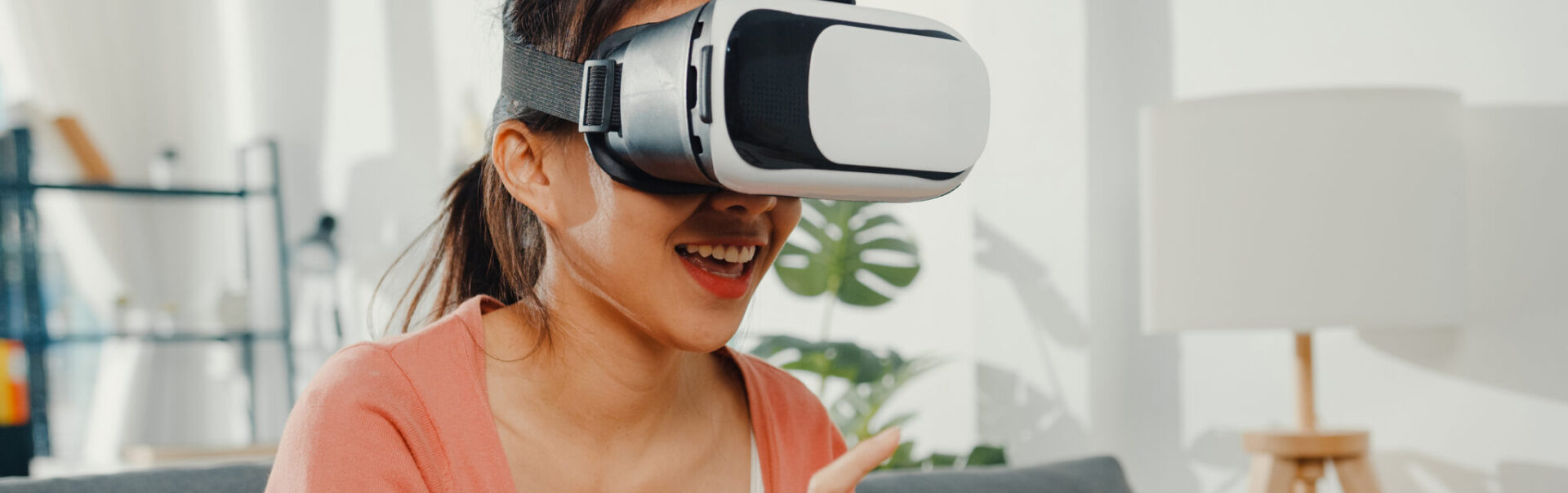 Young person with a VR headset on in a house.